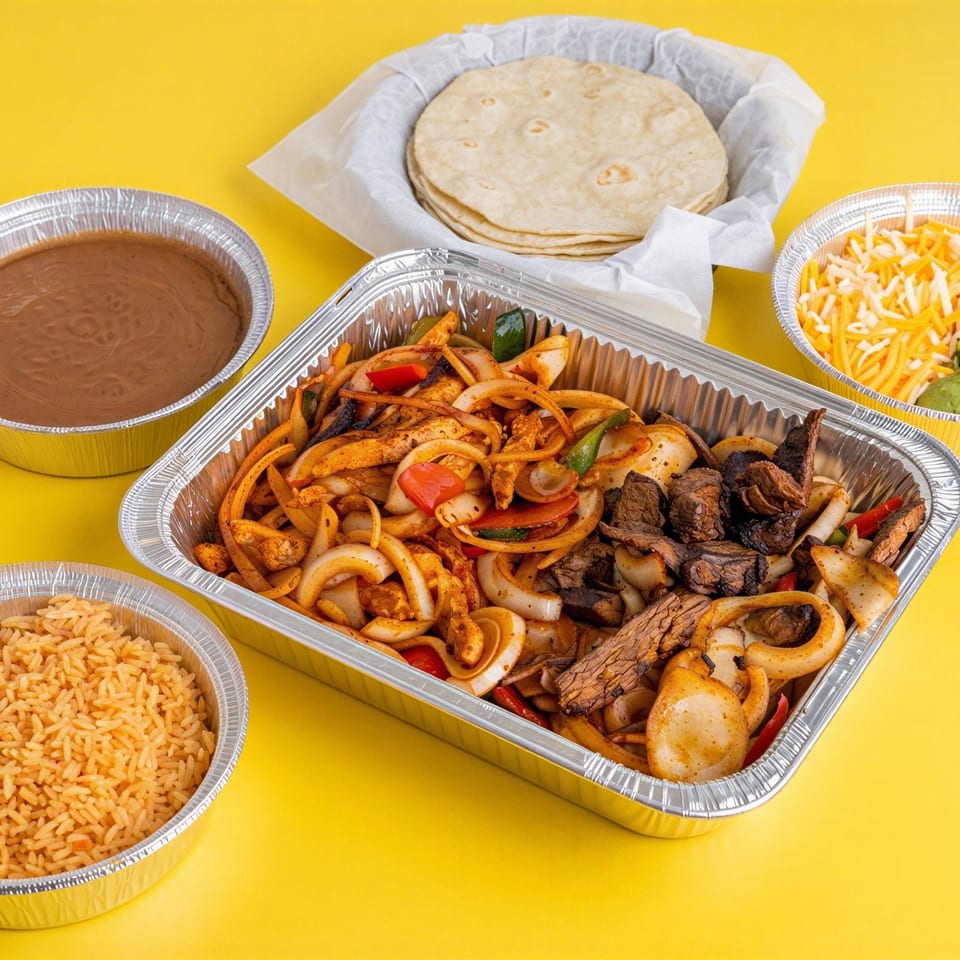 Takeout spread featuring grilled steak and vegetables, Mexican rice, refried beans, tortillas, shredded cheese, and guacamole.