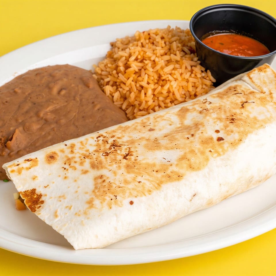 Grilled burrito served with refried beans, Mexican rice, and red salsa on a white plate against a yellow background.